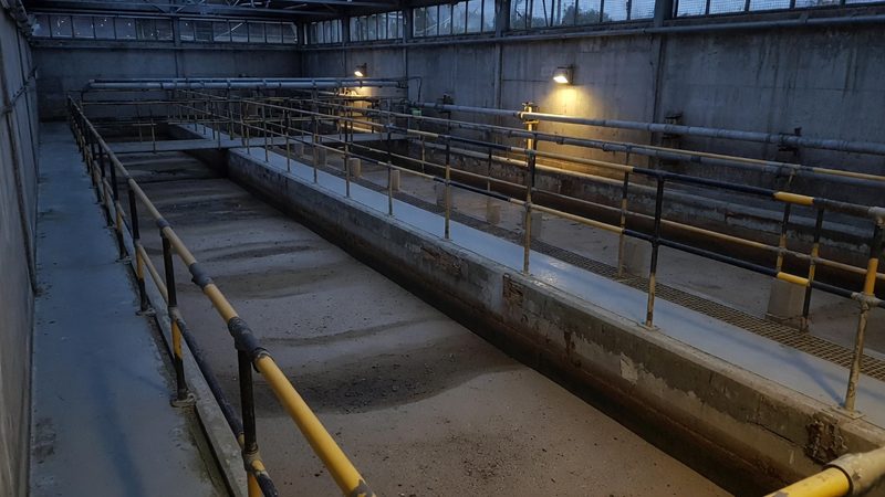 Rapid gravity sand filter beds inside a water treatment works filter hall, long concrete channels, walkways and handrails